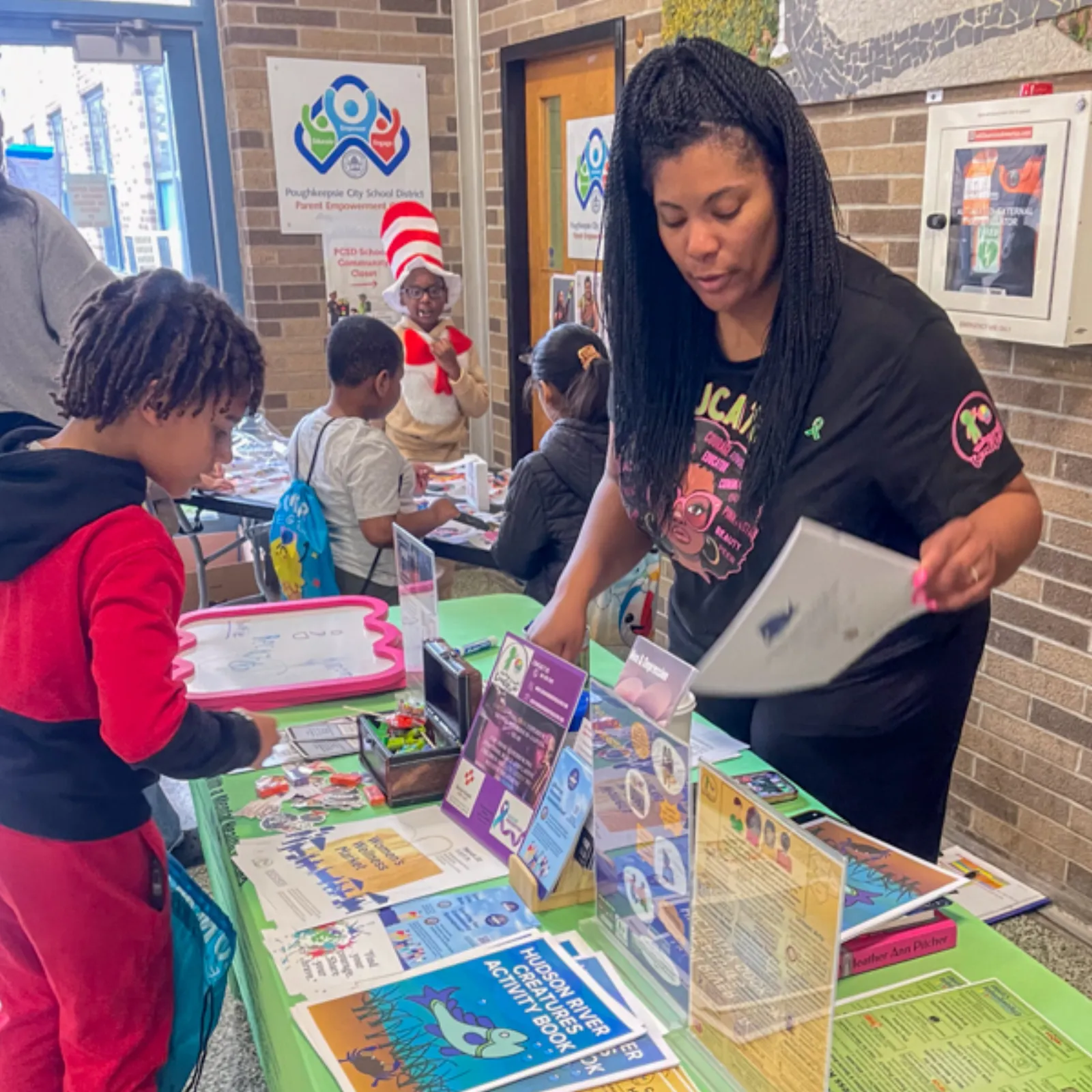 Community volunteers distributing books to Poughkeepsie children