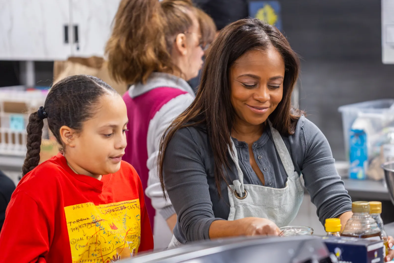 Chef Maureen Brice working with students during the culinary program