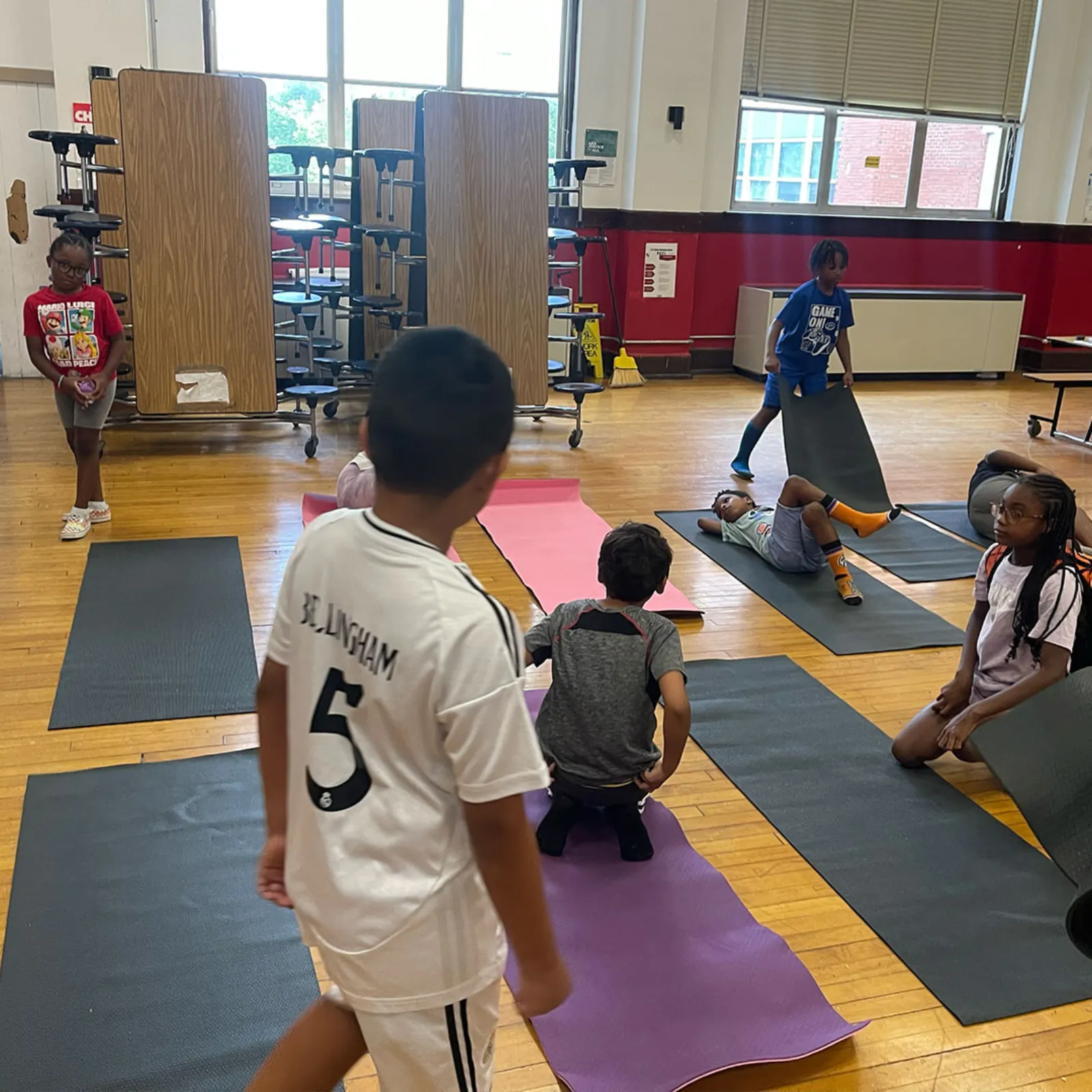 Children setting up their yoga mats before class